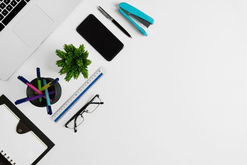 Office supplies on white office desk. Minimal simplicity flat lay with copy space.