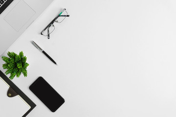 Office supplies on white office desk. Minimal simplicity flat lay with copy space.