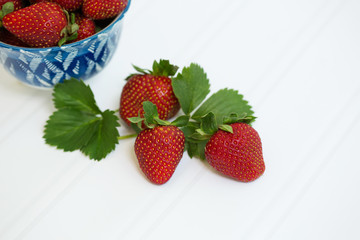 Freshly Picked Strawberries in Blue Bowl on White Tabletop