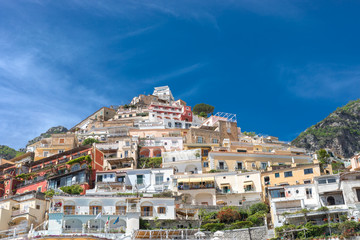 Fototapeta na wymiar Positano Amalfi Coast Neaples Italy - Abstract view of colored houses and windy clouds.