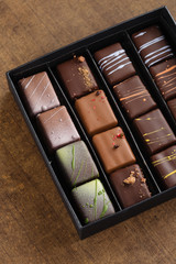 Set of luxury handmade bonbons in a gift box on wooden background