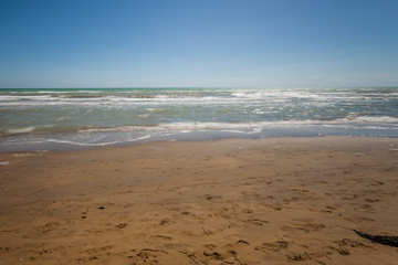 Sandy beach with waves and undertow, Bibione, Veneto, Italy