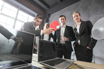 Business people play ping pong