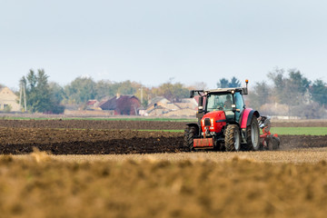 Fototapeta na wymiar Farmer plowing stubble field