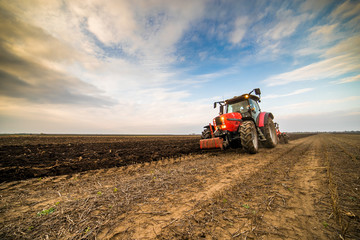 Farmer plowing stubble field