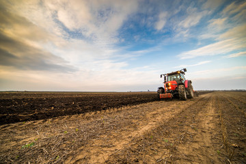 Farmer plowing stubble field