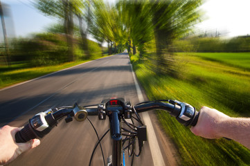 Fototapeta na wymiar Fast bike ride - point of view perspective
