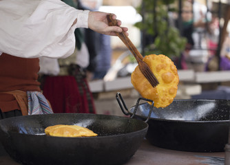 Frying torto de maíz (Corn bread is a typical food in Asturias)