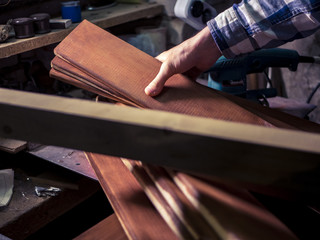 wooden plank in the hand of man working in the dark room