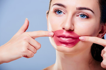 Beautiful young girl with patch on her lips