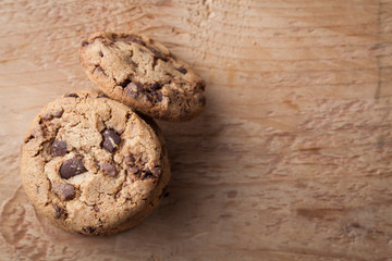 Cookies with chocolate chips on a wooden table. Top view with copy space