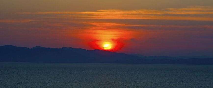 beautiful fiery sunset over the sea © Юлия Моисеенко