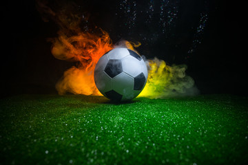 Traditional soccer ball on soccer field. Close up view of soccer ball (football) on green grass...