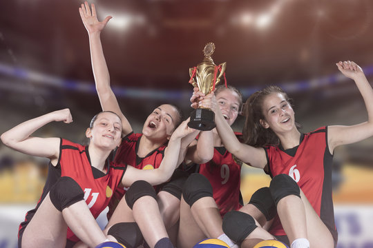 Woman volleyball Players celebrating victory and gold medal