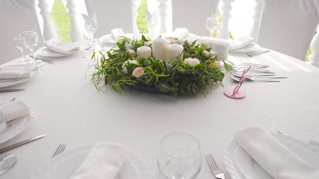 Banquet decorated table, with cutlery. Wedding decor in the banquet hall.Serving of a festive table, plate, napkin, knife, fork. Table setting decoration. Romantic Dinner or other events.