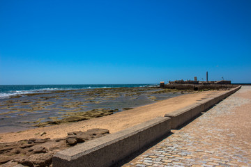 Castle of San Sebastian. A sunny day on the beach of Cadiz. Andalusia, Spain.