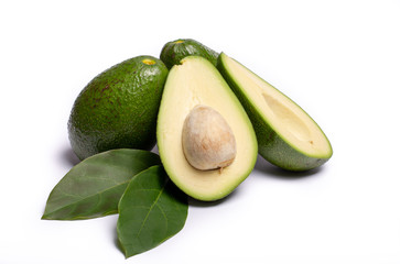 Fresh organic ripe green whole and sliced Fuerte avocado with leaves, copy space close up isolated on white background