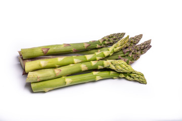 Delicious bunch of raw ripe green asparagus new harvest isolated on white background