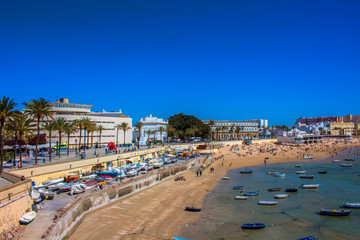 Fototapeta na wymiar Promenade. A sunny day on the beach of Cadiz. Andalusia, Spain. Picture taken – 6 may 2018.