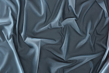 close up view of crumpled blue silk fabric as background