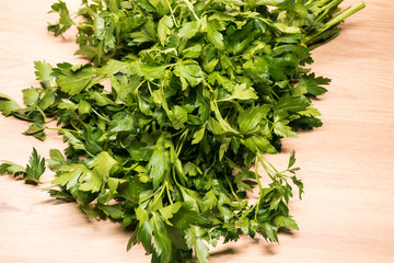 bunch of fresh parsley on a wooden board