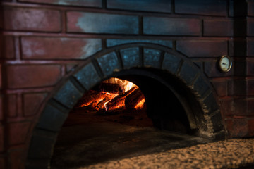 close up view of empty brick oven in restaurant