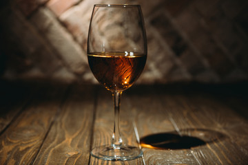 close up view of glass of white wine on wooden surface