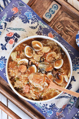 Braise rice with the mixed seafood in a wooden spoon  