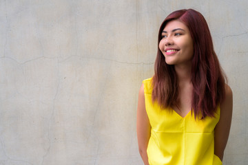 Beautiful teenager girl wearing vibrant yellow shirt