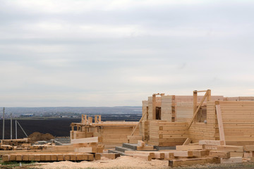 Fototapeta premium construction of wooden houses from a bar