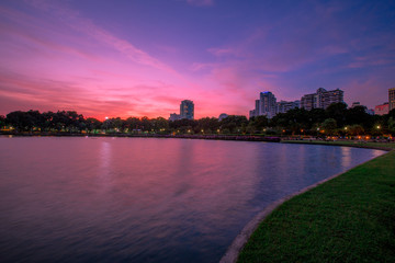 Fototapeta premium Twilight at the park in the heart of Bangkok. Evening People come to relax before going back to the residence (Benjakitti Park)