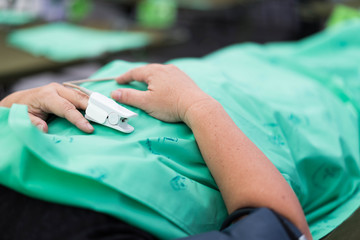 Elderly patient sleeps on pressure in bed in hospital.
