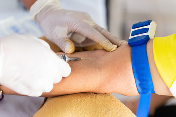 Doctors are using a syringe of blood