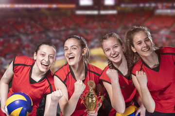 Woman volleyball Players celebrating victory and gold medal
