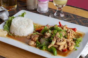 Stir fried vegetables and mushrooms with steamed rice on plate. Restaurant lunch serve in asian style.