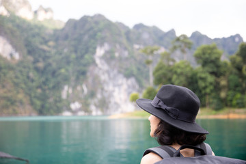 Fototapeta premium Traveler woman looking at destinations sea beach. Summer holiday and vacation trip.