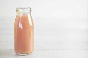 Pink Fruit Smoothy on a White Wood Table