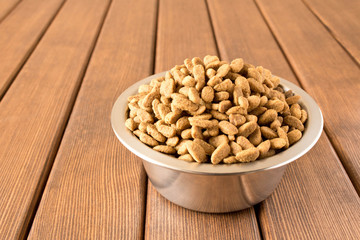 A bowl of dog food on a wooden table