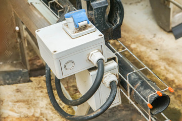 close up damaged electricity gearbox of internal ladder in wind turbine tower