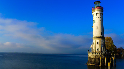 Fototapeta na wymiar view of Lindau Lighthouse with sea and blue sky background , Germany