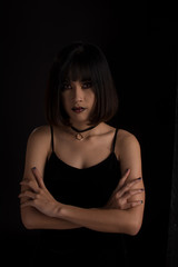 Portrait of a lady in dark tone, asian woman on black background