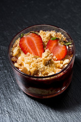dessert with fresh strawberries, biscuits and cream on dark background, vertical