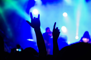 Crowd at concert - silhouettes of concert crowd in front of bright stage lights