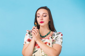 Naklejka premium Confident girl smiling to camera. Portrait of woman over blue background
