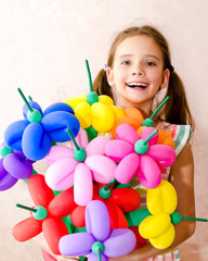 Portrait of smiling adorable little girl child with balloons