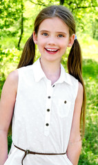 Portrait of adorable smiling little girl outdoors