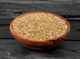 Split Roasted Coriander Seeds in Wooden Bowl also know as Dhana Dal or Sukh Mukh on Wooden Table