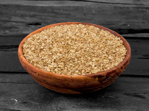 Split Roasted Coriander Seeds in Wooden Bowl also know as Dhana Dal or Sukh Mukh on Wooden Table