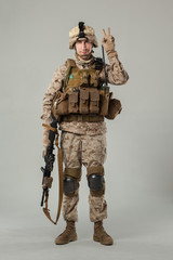 Soldier in camouflage holding rifle