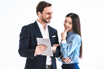 The business couple with a tablet standing on the white background